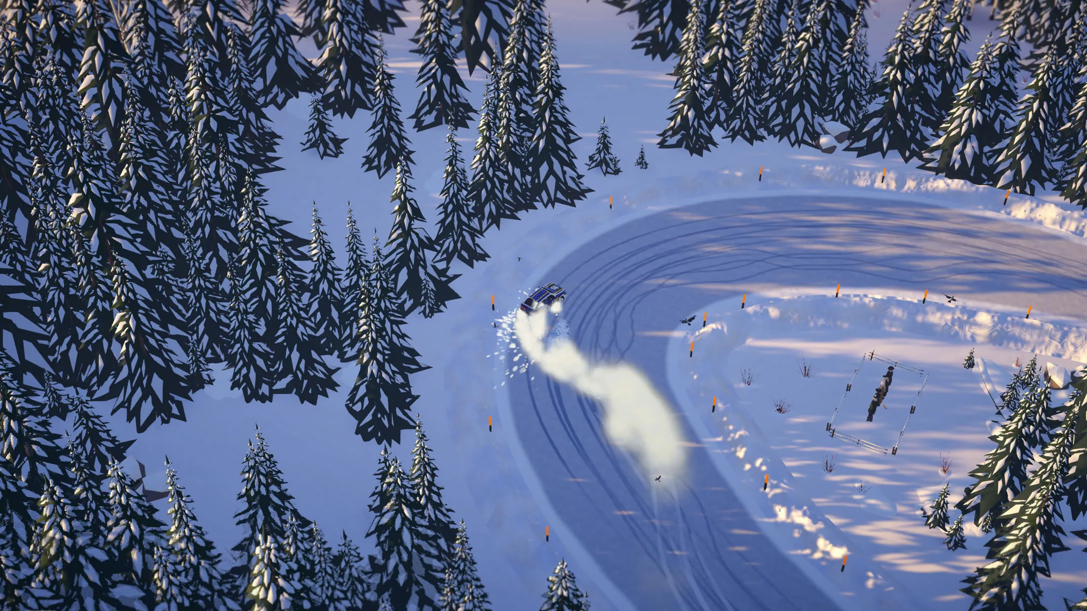 A snowy hairpin in a spruce forest seen from above, a car throwing up a plume of snow